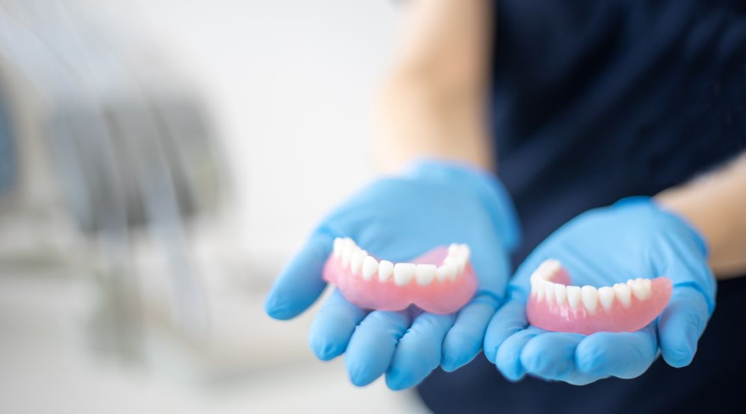 What’s the Difference Between a Bridge and Dentures?